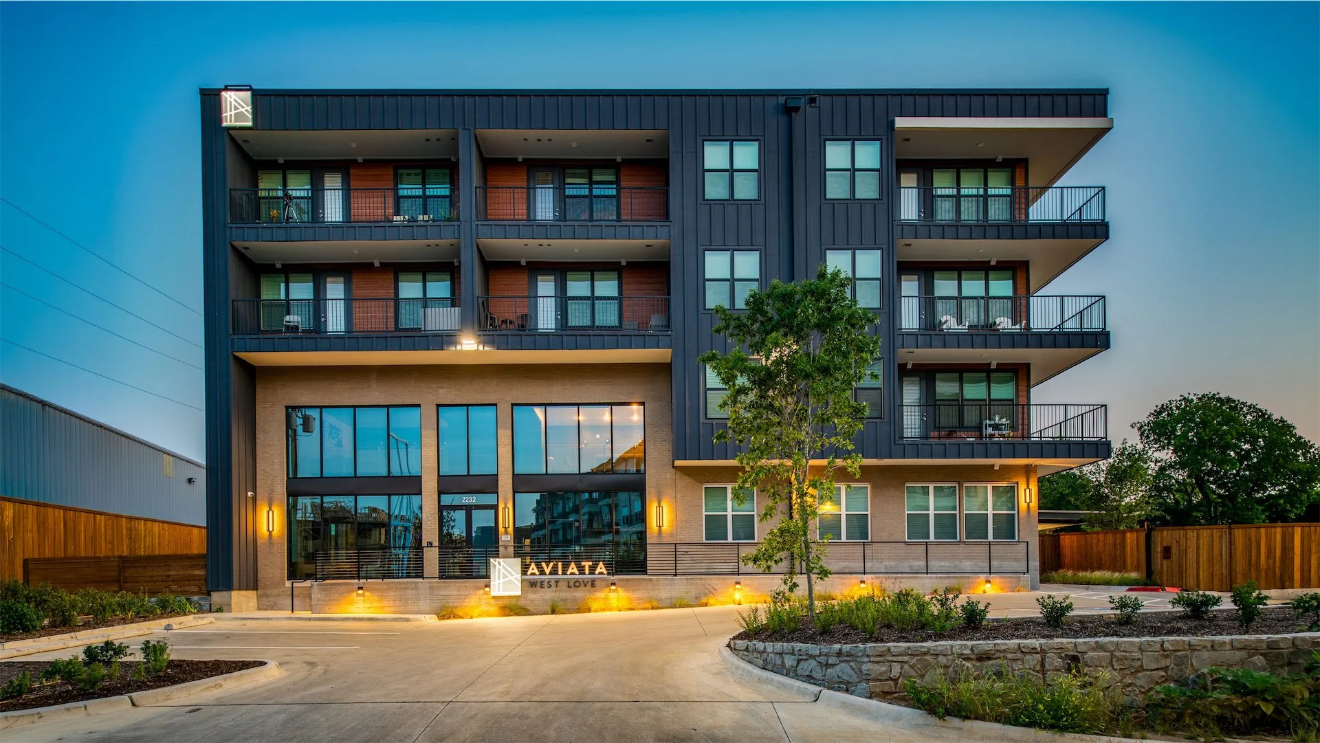 Aviata West Love apartment building exterior at dusk