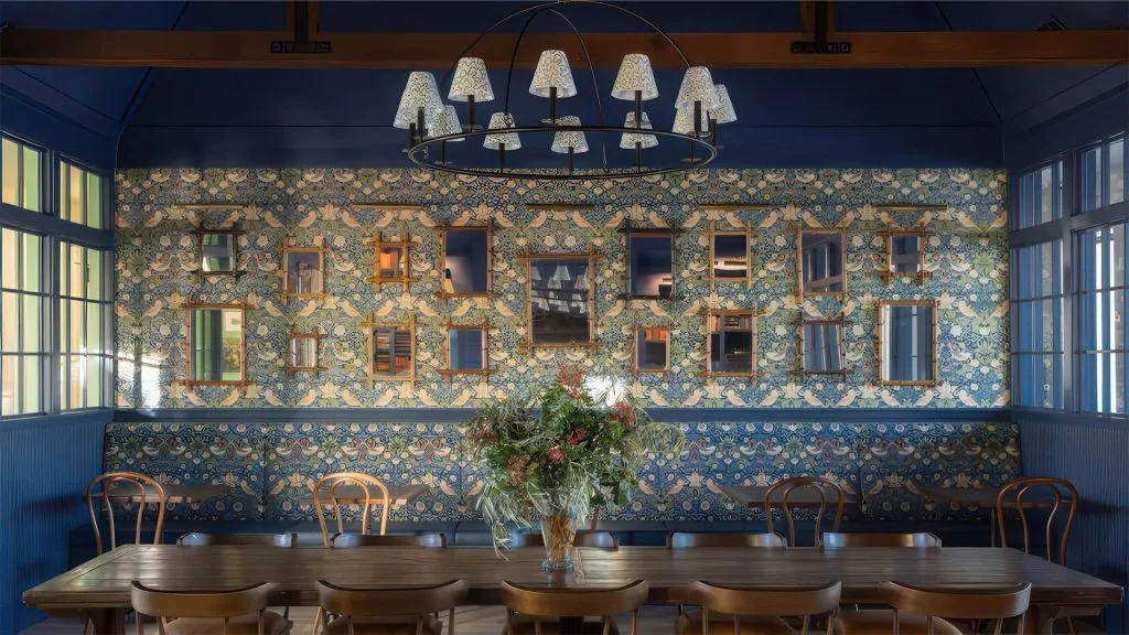 Kelly Hollow clubhouse dining room with patterned wallpaper and chandelier